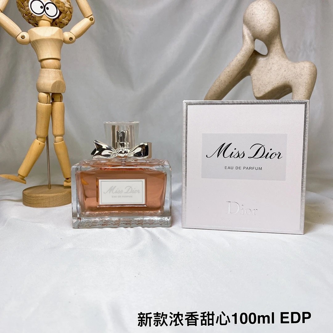 Miss Dior perfume bottle and packaging on a gray background