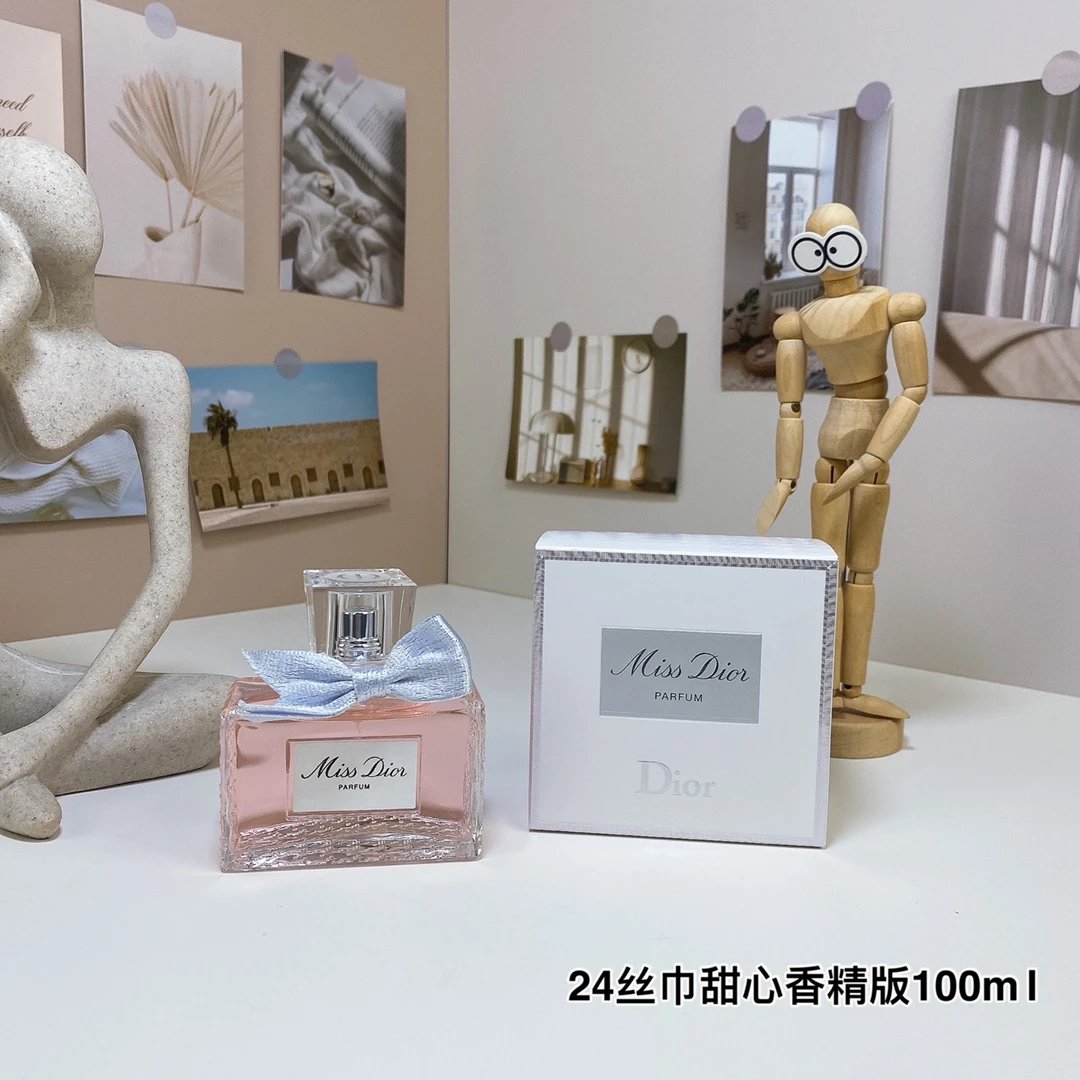 Miss Dior perfume bottle and packaging on a table with decorative items.