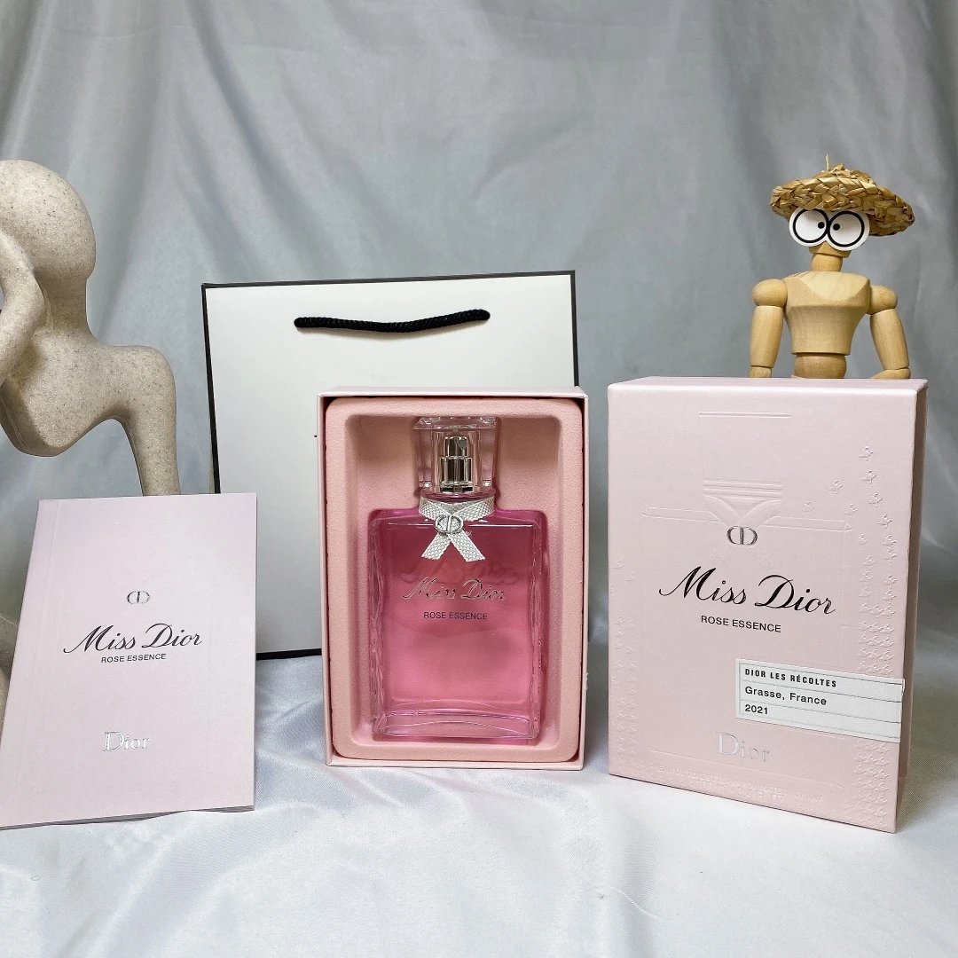 Miss Dior perfume bottle and packaging on a white surface with a gray background