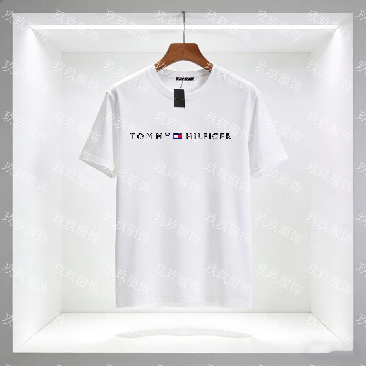 White Tommy Hilfiger t-shirt on a hanger with a clear background