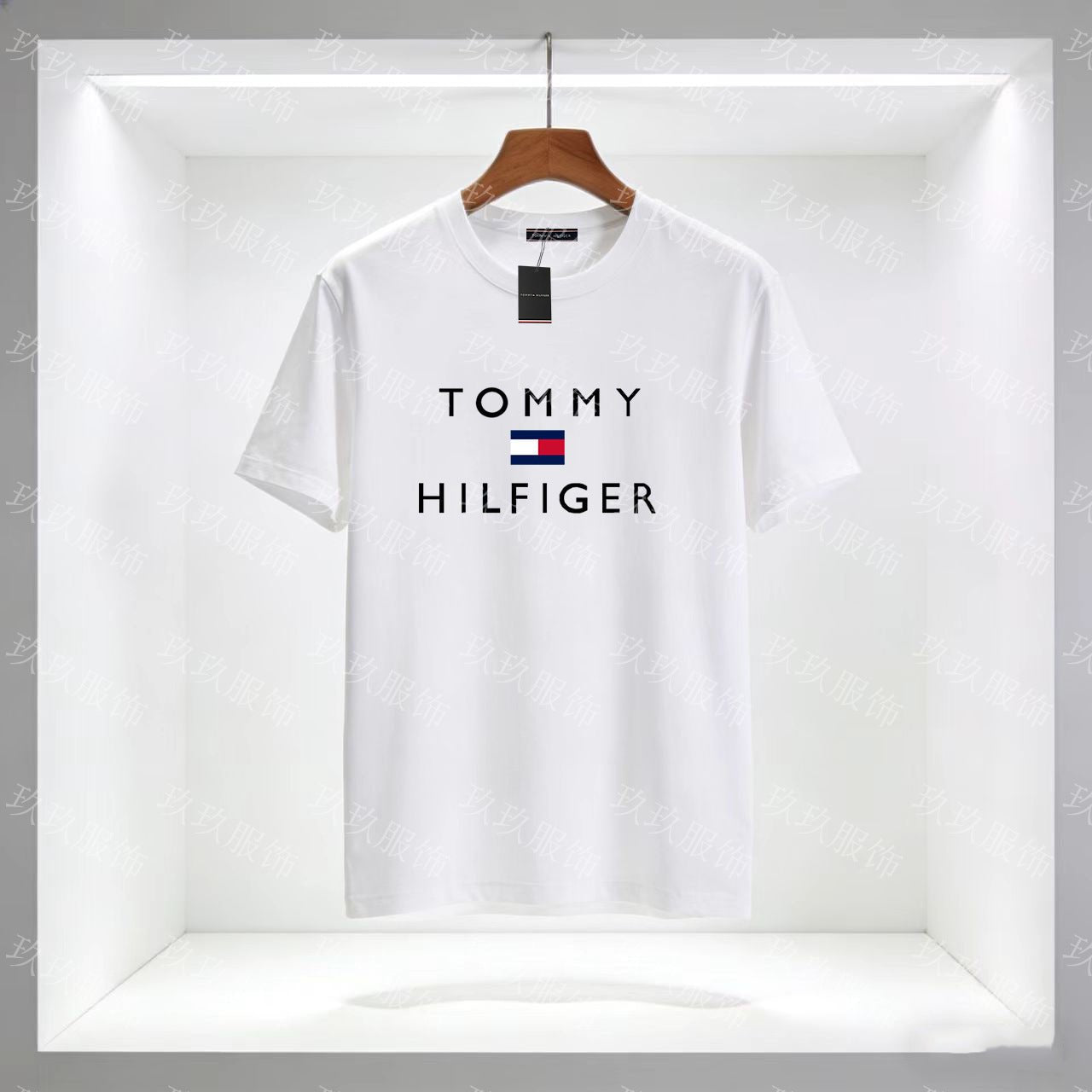 White Tommy Hilfiger t-shirt on a hanger with a clear background