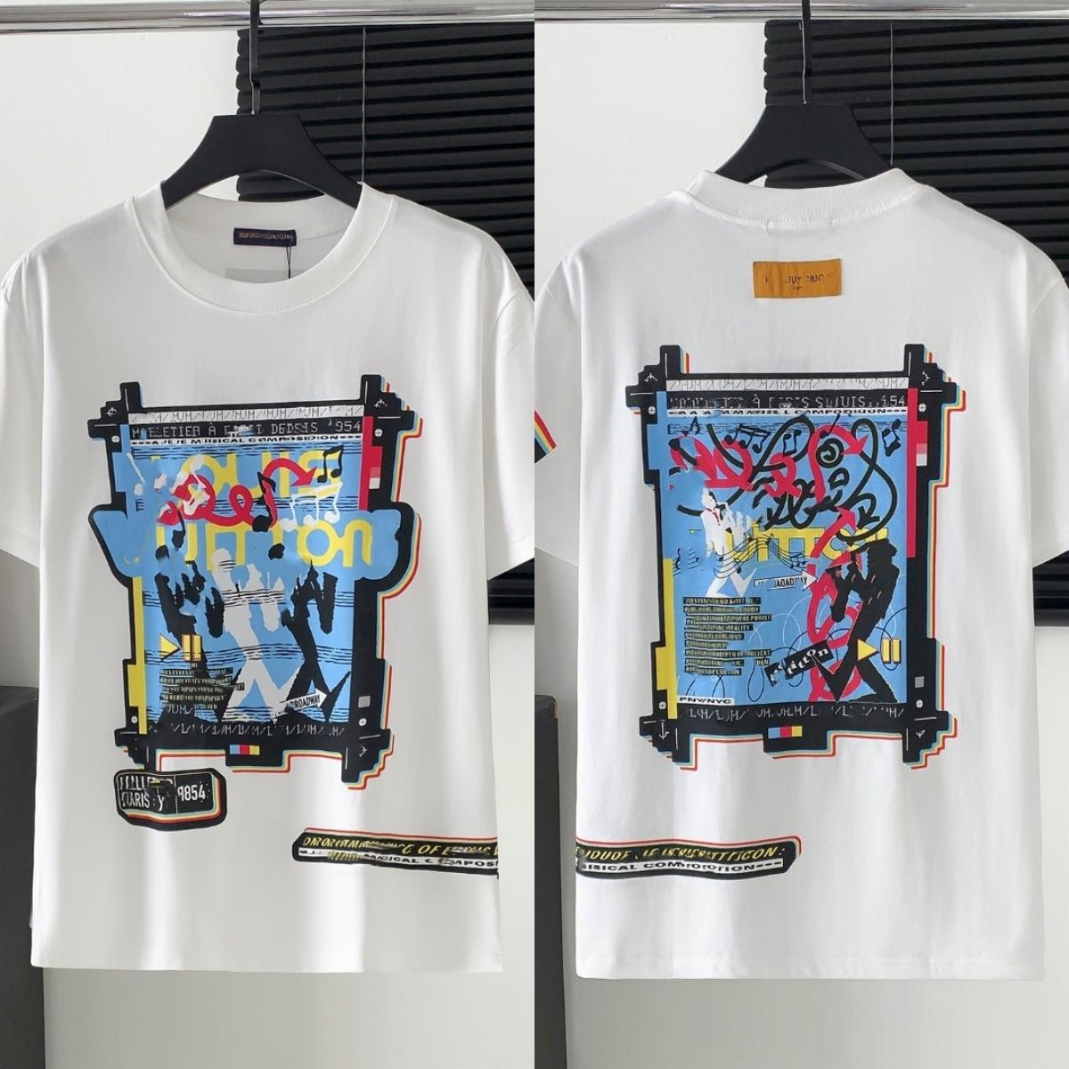 White t-shirt with colorful graphic design on a hanger against a white background