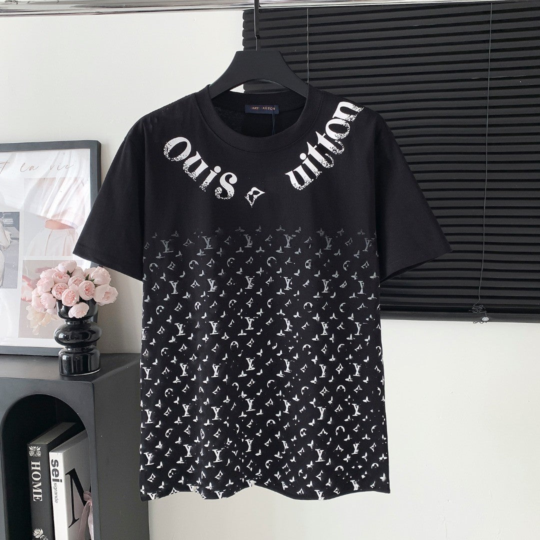 Black t-shirt with white pattern and text on a hanger against a neutral background