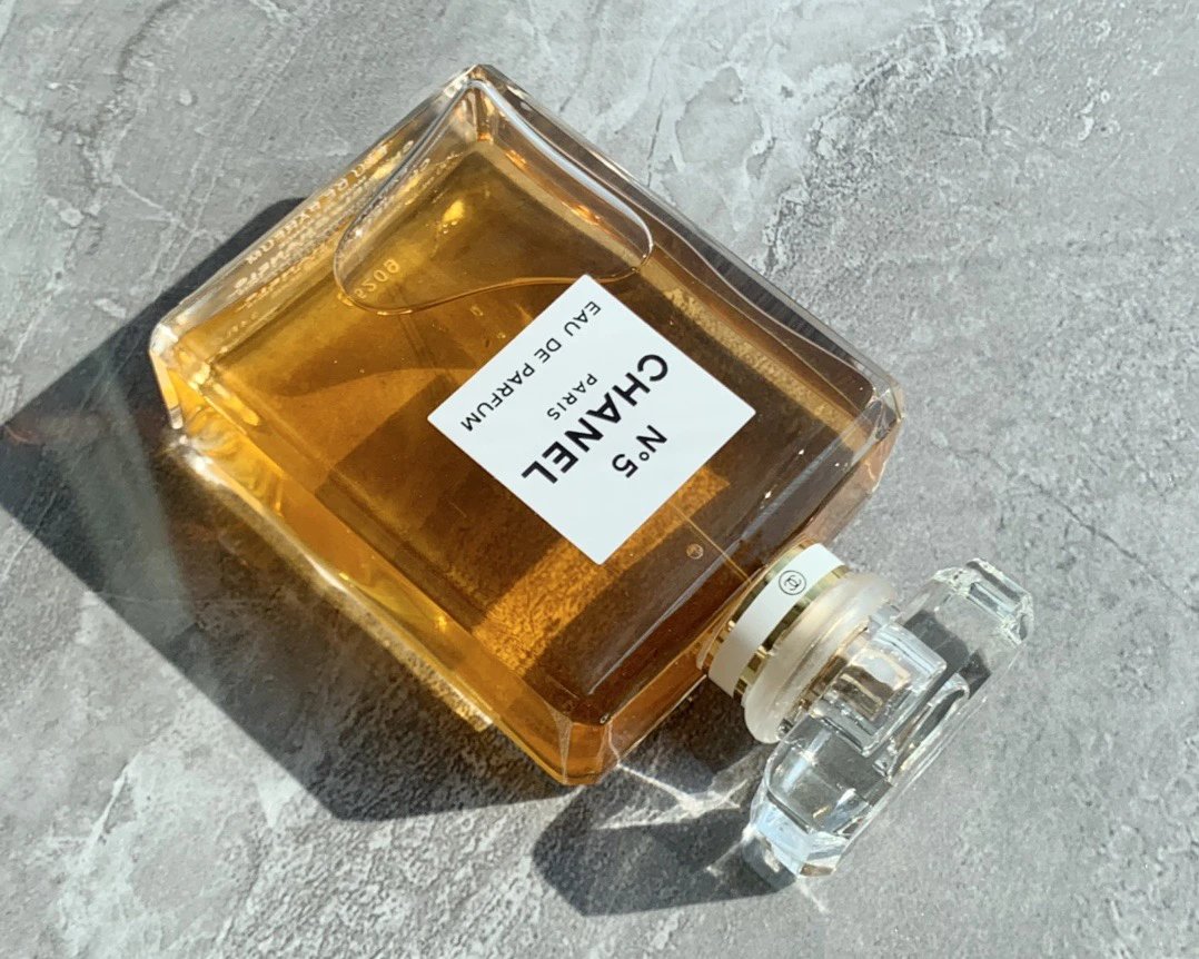 Perfume bottle with a visible label on a gray surface